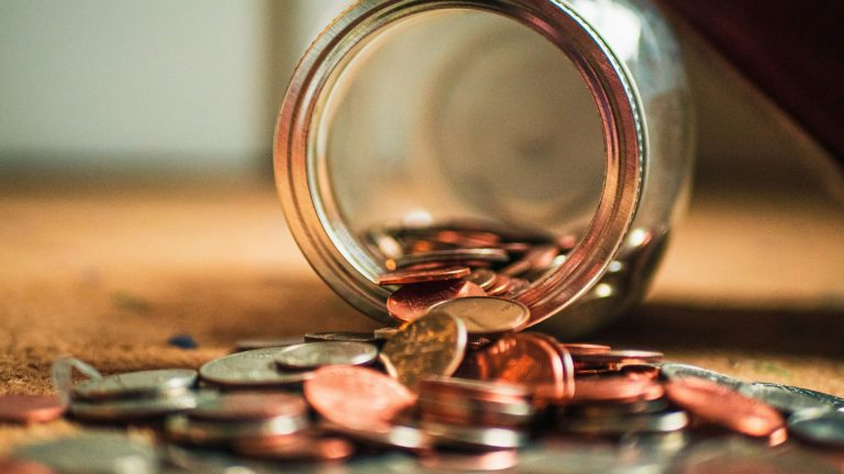 coins falling out of a jar